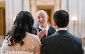 Officiator with Bride and Groom