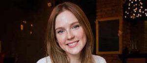 Young brunette woman at desk.